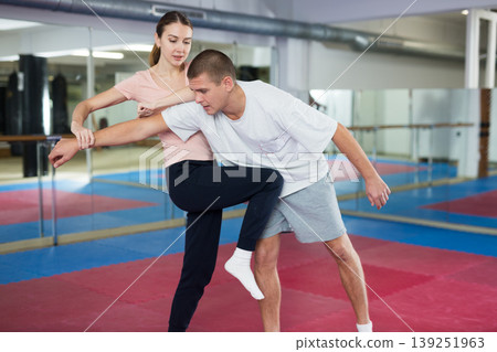 Woman performing knee strike during self-defence training Woman performing knee strike during self-defence training 139251963