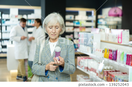 Mature woman chooses lubricant and intimate hygiene items in pharmacy 139252043