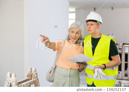 Teenager helping senior woman with home improvement works Teenager helping senior woman with home improvement works 139252137