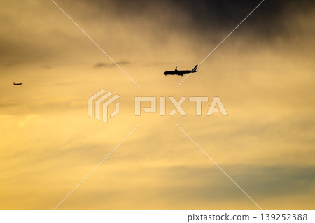 Airplane flying over Tamsui Bridge in New Taipei City at sunset Airplane flying over Tamsui Bridge in New Taipei City at sunset 139252388