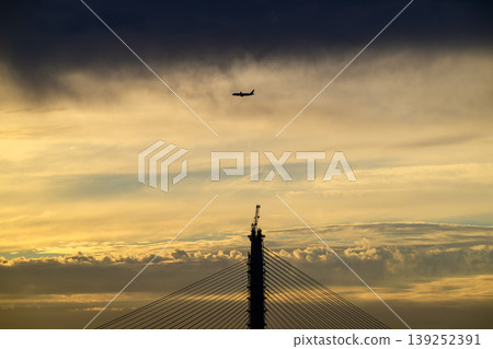 Airplane Flying Over Danjiang Bridge at Sunset in New Taipei City Airplane Flying Over Danjiang Bridge at Sunset in New Taipei City 139252391