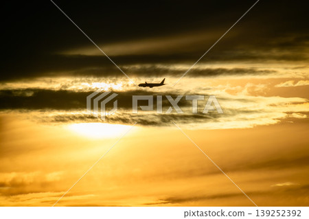 Airplane silhouette flying over Tamsui Bridge at sunset in Taiwan Airplane silhouette flying over Tamsui Bridge at sunset in Taiwan 139252392