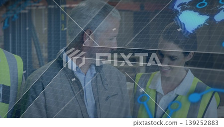 Reviewing AR overlay warehouse staff examining digital grid in aisle with safety vests and shelving Reviewing AR overlay warehouse staff examining digital grid in aisle with safety vests and shelving 139252883