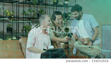 Collaborating coworkers reviewing smartphone graph in office lounge holding coffee cups, tablet Collaborating coworkers reviewing smartphone graph in office lounge holding coffee cups, tablet 139252918
