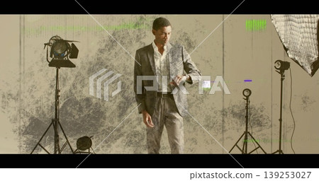 Glancing mid-adult model in grey suit checking wristwatch in studio, with studio lights Glancing mid-adult model in grey suit checking wristwatch in studio, with studio lights 139253027