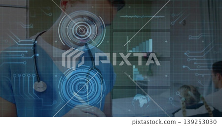 Gesturing doctor in blue scrubs with stethoscope reviewing AR interface in clinic, with wheelchair Gesturing doctor in blue scrubs with stethoscope reviewing AR interface in clinic, with wheelchair 139253030