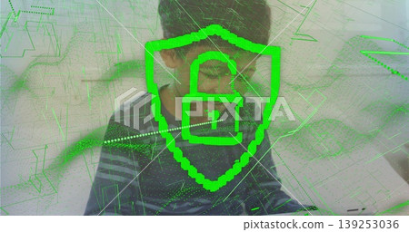 Focusing boy wearing glasses using laptop at home, with green shield and unlocked padlock overlay Focusing boy wearing glasses using laptop at home, with green shield and unlocked padlock overlay 139253036