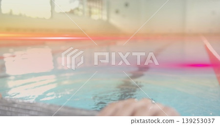 Hand gripping metal pool edge at swimming pool, showing window glare on lane stripe, copy space Hand gripping metal pool edge at swimming pool, showing window glare on lane stripe, copy space 139253037