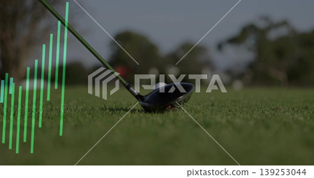 Resting golf driver head and golf ball on tee on fairway, with translucent green bar chart Resting golf driver head and golf ball on tee on fairway, with translucent green bar chart 139253044