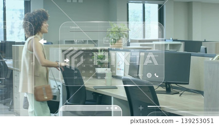 Walking office worker in business casual through open-plan office with digital overlays, copy space Walking office worker in business casual through open-plan office with digital overlays, copy space 139253051