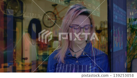 Woman wearing striped apron crafting in workshop and examining digital overlay near bicycle mounted Woman wearing striped apron crafting in workshop and examining digital overlay near bicycle mounted 139253058