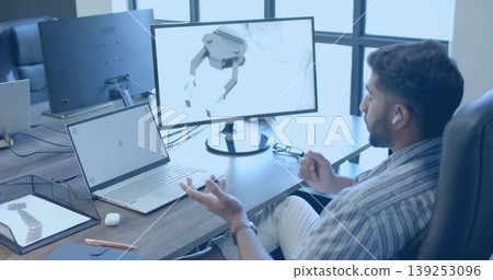 Designer modeling robotic gripper on monitor in modern tech office, with laptop tablet, copy space Designer modeling robotic gripper on monitor in modern tech office, with laptop tablet, copy space 139253096