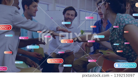 Seven professionals joining hands in loft office, with chairs and digital overlay tags Seven professionals joining hands in loft office, with chairs and digital overlay tags 139253097