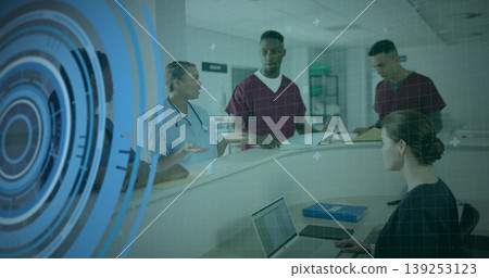 Stethoscope clad nurse briefing colleagues reviewing charts at hospital reception, laptop overlay Stethoscope clad nurse briefing colleagues reviewing charts at hospital reception, laptop overlay 139253123