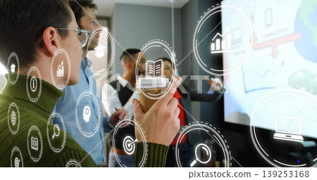 Presenting woman in green sweater holding coffee cup in conference room with tech icons, copy space Presenting woman in green sweater holding coffee cup in conference room with tech icons, copy space 139253168
