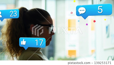 Monitoring woman with glasses turtleneck sitting in office, with notification icons, copy space 139253171