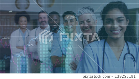 Standing nurse wearing scrubs and stethoscope in clinic corridor, digital chart overlay, copy space Standing nurse wearing scrubs and stethoscope in clinic corridor, digital chart overlay, copy space 139253191
