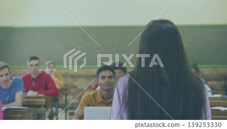 Teenage female student presenting in high school classroom with desks laptop chalkboard, copy space Teenage female student presenting in high school classroom with desks laptop chalkboard, copy space 139253330
