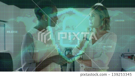 Two mid-adult women collaborating in modern office, holding tablet with digital world map overlay Two mid-adult women collaborating in modern office, holding tablet with digital world map overlay 139253345