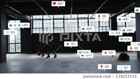 Woman and man in sportswear playing basketball in warehouse court, with notification icons Woman and man in sportswear playing basketball in warehouse court, with notification icons 139253533