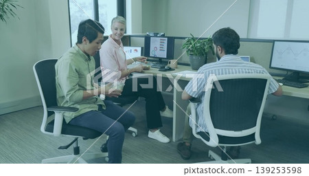 Eating lunch, three office coworkers sharing salad bowls at corner desk, with monitors and plant Eating lunch, three office coworkers sharing salad bowls at corner desk, with monitors and plant 139253598