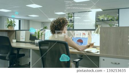 Data analyst in sleeveless blouse reviewing charts on laptop monitors at office, with code overlay Data analyst in sleeveless blouse reviewing charts on laptop monitors at office, with code overlay 139253635