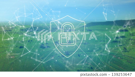 Hovering white digital shield icon securing rolling green fields under network nodes, lines overlay Hovering white digital shield icon securing rolling green fields under network nodes, lines overlay 139253647