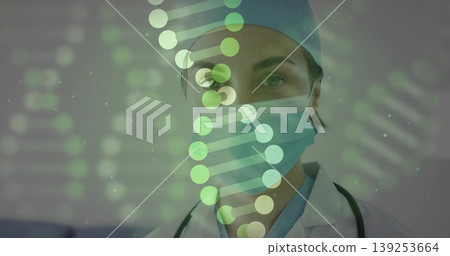 Displaying female medic analyzing DNA helix overlay in lab, with stethoscope mask cap lab coat Displaying female medic analyzing DNA helix overlay in lab, with stethoscope mask cap lab coat 139253664