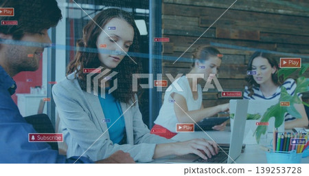 Typing project lead in gray blazer collaborating over laptops on office desk, with code overlays Typing project lead in gray blazer collaborating over laptops on office desk, with code overlays 139253728