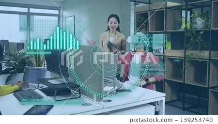 Collaborating coworkers exploring virtual data in open-plan office, with VR headset, tablet, laptop Collaborating coworkers exploring virtual data in open-plan office, with VR headset, tablet, laptop 139253740