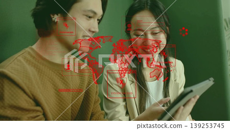 IT colleagues examining tablet screen in office with red map overlay and SYSTEM HACKED alert IT colleagues examining tablet screen in office with red map overlay and SYSTEM HACKED alert 139253745