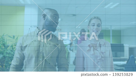 Walking mid adult colleagues in office attire through modern office, with overlaid financial charts Walking mid adult colleagues in office attire through modern office, with overlaid financial charts 139253829
