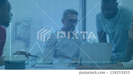 Collaborating business team typing on laptop in boardroom with notepad pen papers, chart overlay Collaborating business team typing on laptop in boardroom with notepad pen papers, chart overlay 139253833