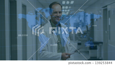 Reviewing data doctor holding tablet in clinical corridor, with stethoscope and world map overlay Reviewing data doctor holding tablet in clinical corridor, with stethoscope and world map overlay 139253844