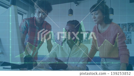 Colleagues reviewing data trends in modern office at desk, with laptop, monitor and graph overlay Colleagues reviewing data trends in modern office at desk, with laptop, monitor and graph overlay 139253852