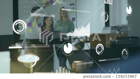 Three colleagues in business attire organizing data on display board in boardroom with sticky notes Three colleagues in business attire organizing data on display board in boardroom with sticky notes 139253967