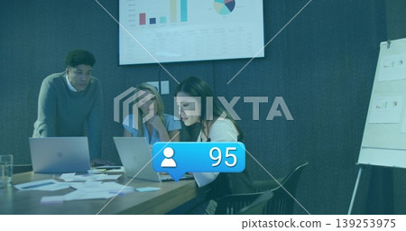 Reviewing data three professionals collaborating around conference table, with laptops and charts 139253975