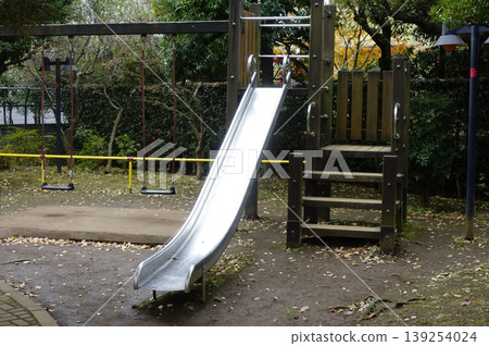 A slide in a deserted park A slide in a deserted park 139254024
