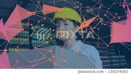 Holding cardboard box woman wearing helmet stocking bottles on warehouse racks, network overlay Holding cardboard box woman wearing helmet stocking bottles on warehouse racks, network overlay 139254083