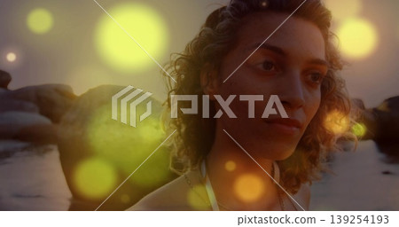 Gazing woman wearing white halter swimsuit and necklace at beach sunset, lens flares, copy space Gazing woman wearing white halter swimsuit and necklace at beach sunset, lens flares, copy space 139254193