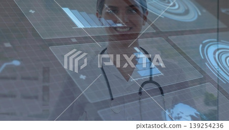 Standing female physician analyzing floating data on digital display in clinic with stethoscope Standing female physician analyzing floating data on digital display in clinic with stethoscope 139254236