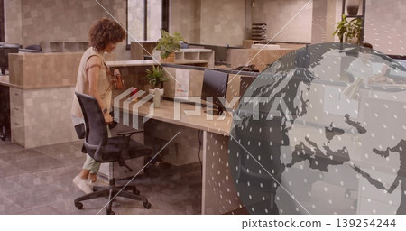 Woman wearing business casual retrieving purse from adjustable chair at cubicle desk, copy space 139254244