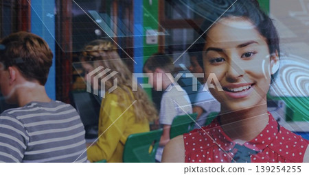 Posing student wearing red polka dot blouse in school computer lab, with computers and grid overlay Posing student wearing red polka dot blouse in school computer lab, with computers and grid overlay 139254255