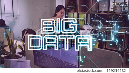Inspecting VR headset and reviewing data charts, Chinese IT professional working at office desk Inspecting VR headset and reviewing data charts, Chinese IT professional working at office desk 139254282