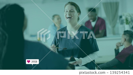 Laughing nurse holding plate with chocolate cake, fork in cafeteria, heart icon showing 3908 likes Laughing nurse holding plate with chocolate cake, fork in cafeteria, heart icon showing 3908 likes 139254341