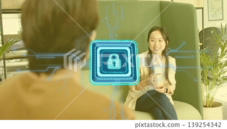 Talking woman in beige blazer holding coffee mug in office lounge, digital lock overlay, copy space Talking woman in beige blazer holding coffee mug in office lounge, digital lock overlay, copy space 139254342