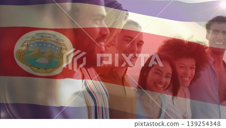 Standing six smiling friends wearing clothes outdoors at sunset, with Costa Rica flag crest overlay Standing six smiling friends wearing clothes outdoors at sunset, with Costa Rica flag crest overlay 139254348