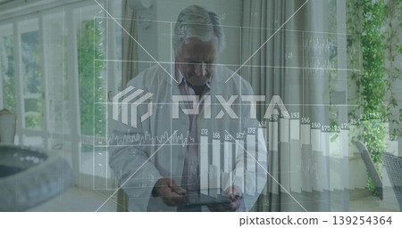 Senior researcher interpreting augmented data in consulting room, with tablet and floating charts 139254364