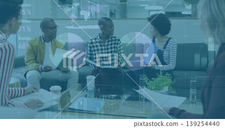 Discussing project, five colleagues holding tablet and papers around lounge table, with coffee cups Discussing project, five colleagues holding tablet and papers around lounge table, with coffee cups 139254440