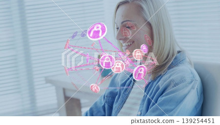 Woman sitting at desk in home office smiling at 3D network visualization, copy space 139254451